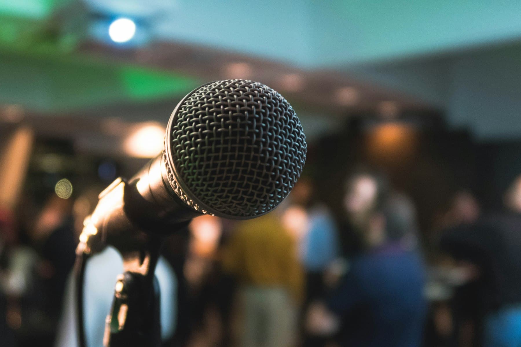 A microphone at a meetup with the audience out of focus