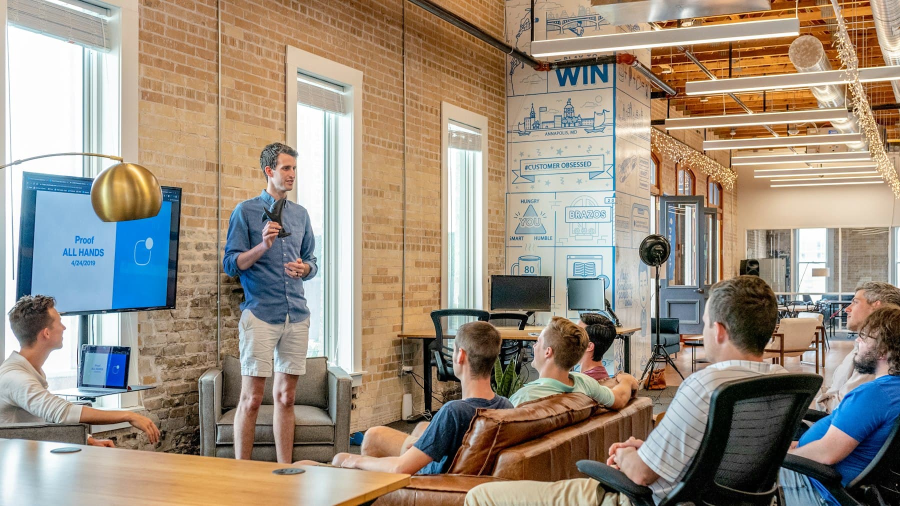 A speaker presenting to a small group in a loft space