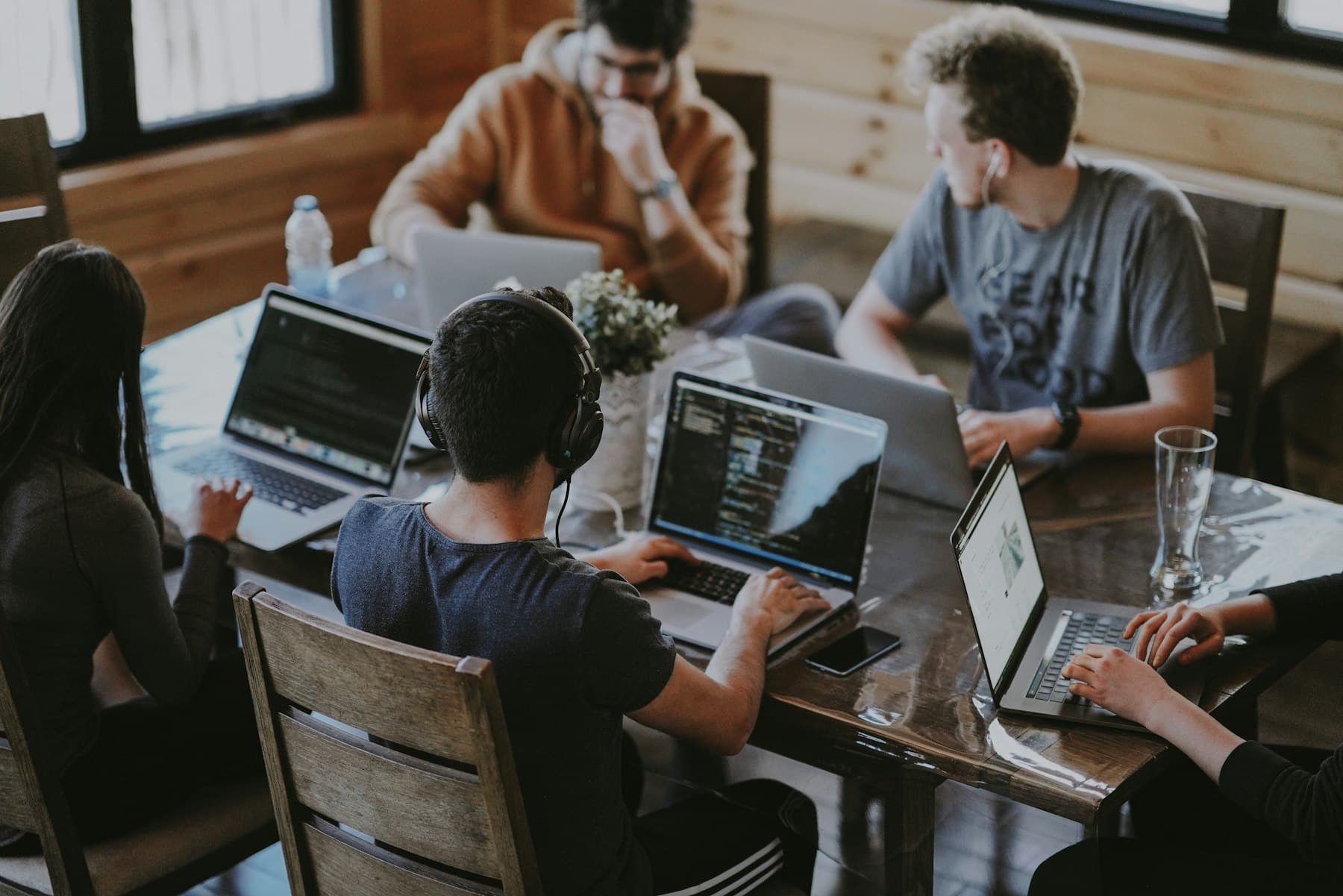 A team working side by side on laptops